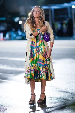 carrie bradshaw on the street wearing a rainbow midi dress