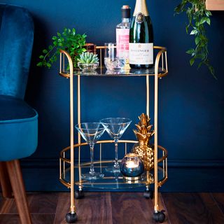 Drinks trolley with indigo wall and cocktail glasses