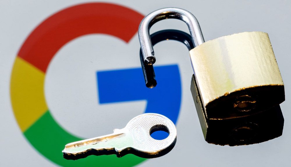 A padlock resting on a mirror reflecting the Google logo