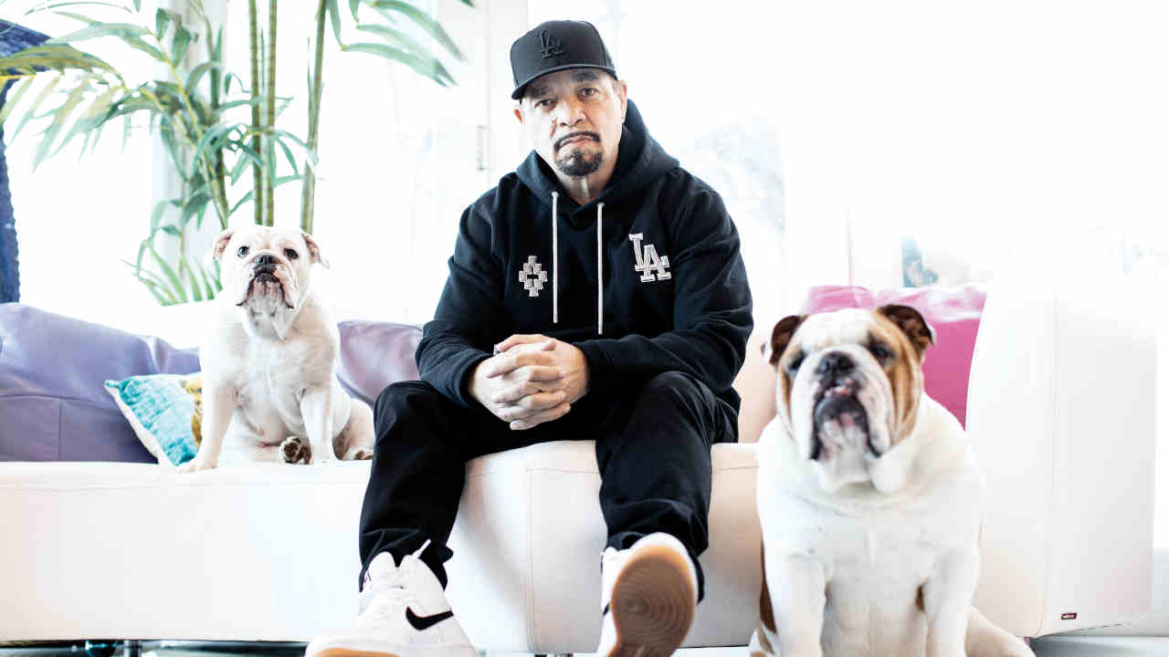 Ice T posing for a photograph at home with his dogs