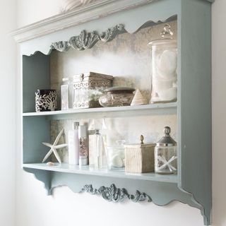 dresser with shelves and white wall