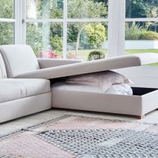 L-shaped sofa with storage in conservatory