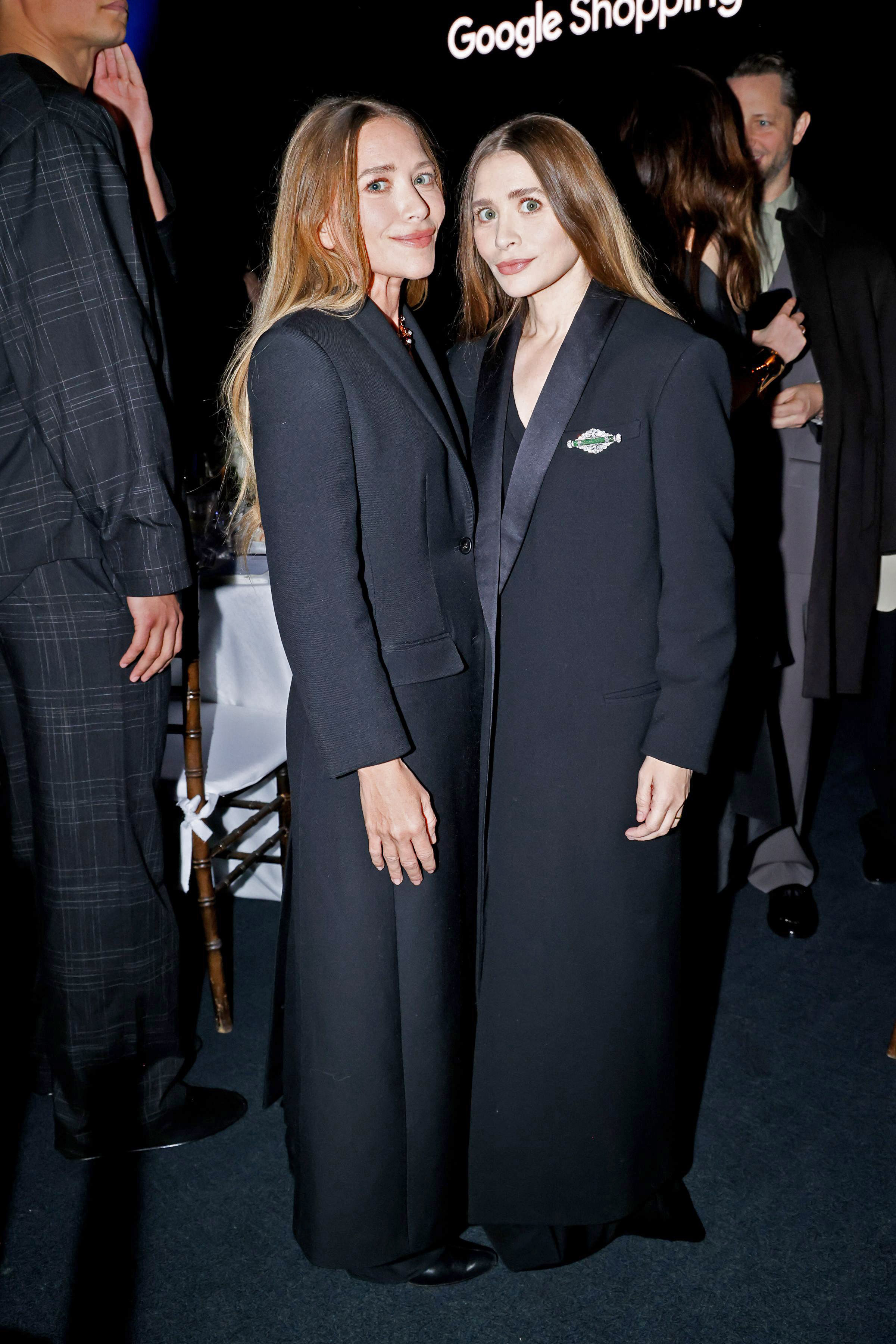 Ashley and Mary-Kate Olsen wearing matching black coats at the 2025 CFDA Awards in New York City.