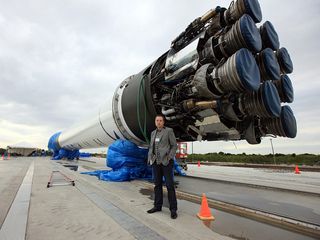 SpaceX CEO Elon Musk stands next to the company's Falcon 9 rocket, which blasted SpaceX's Dragon capsule into orbit in December 2010.