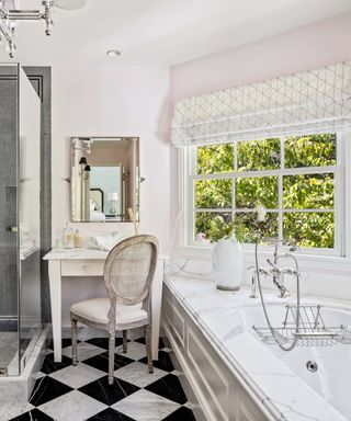 White bathroom with large bath tub and dressing table