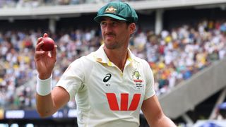 Mitchell Starc of Australia holds the ball aloft after taking 7 for 58 during day one of the First 2025/26 Ashes Series Test Match between Australia and England at Perth Stadium on November 21, 2025 in Perth, Australia. 