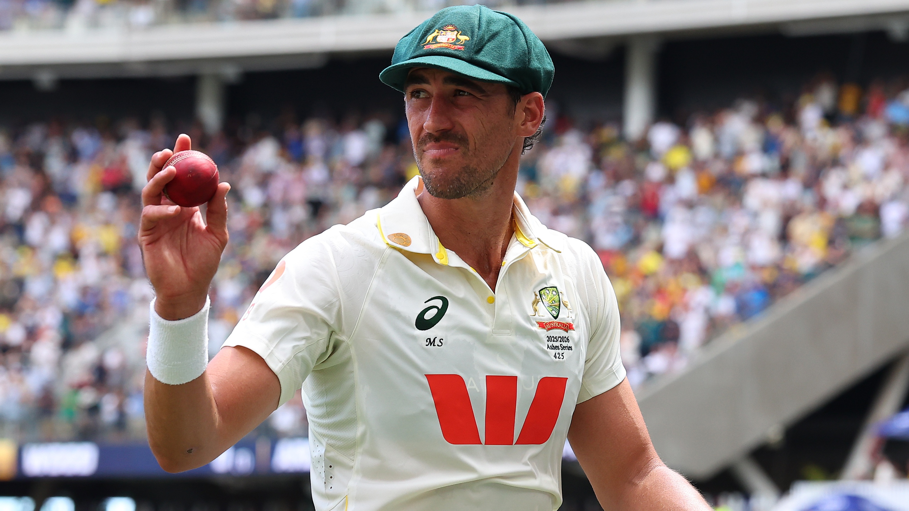 Mitchell Starc of Australia holds the ball aloft after taking 7 for 58 during day one of the First 2025/26 Ashes Series Test Match between Australia and England at Perth Stadium on November 21, 2025 in Perth, Australia. 