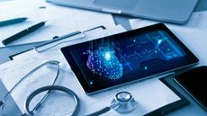 stethoscope and tablet on top of medical records