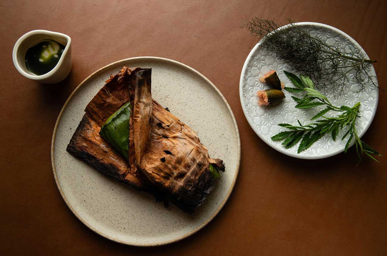 Kiln chef, Beau Clugston's, signature Australian bush-inspired dish &amp;ndash; leeks cooked in paperbark, dabbed with native finger lime
