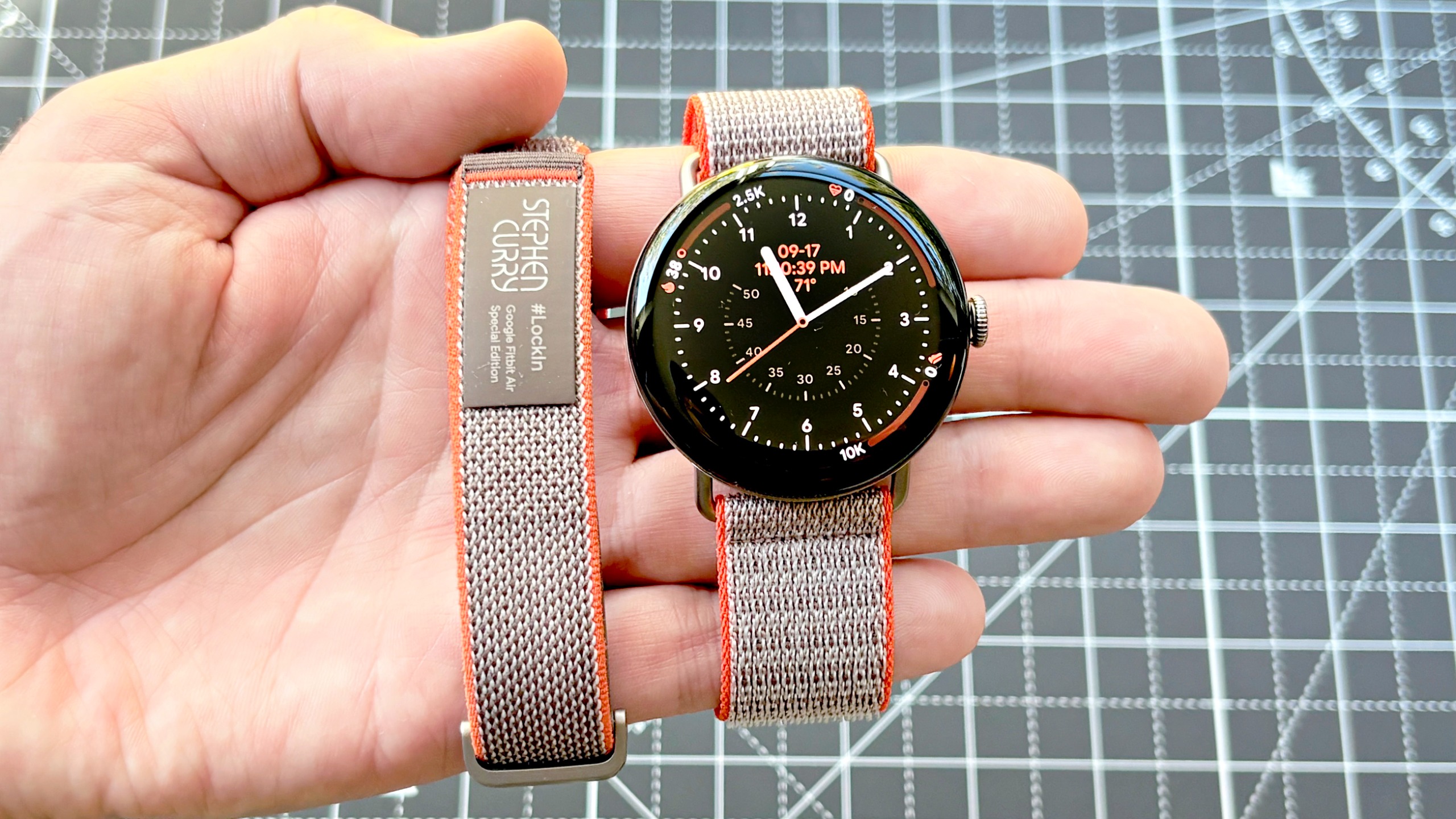 Close-up of the Google Pixel Watch 5 Stephen Curry special edition smartwatch next to the Fitbit Air Stephen Curry model