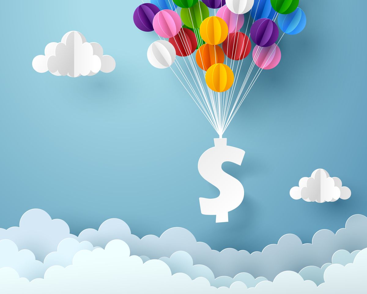 A dollar sign attached to balloons floats against a sky with clouds