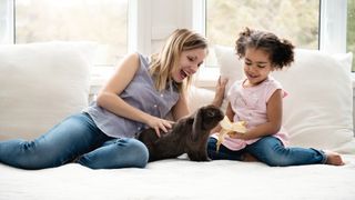 Mother and daughter with pet rabbit