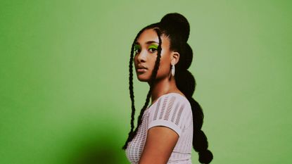 woman with bubble braids green background