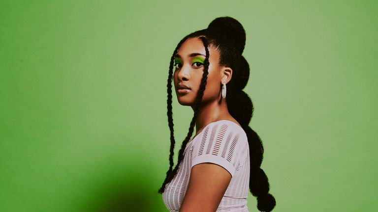 woman with bubble braids green background