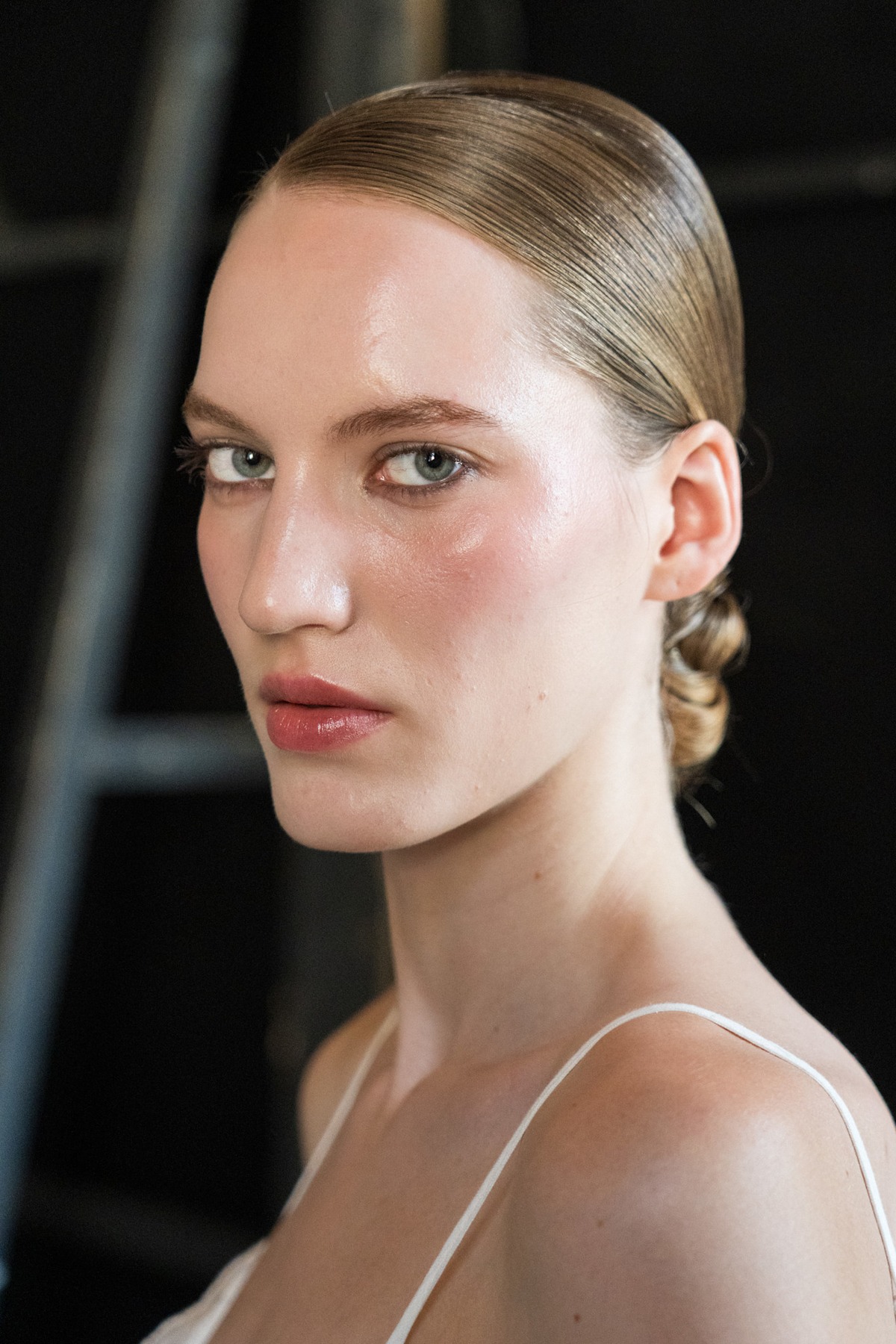 A model showing off a side-parted wedding hairstyle.
