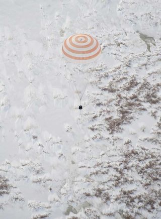 The Soyuz TMA-16 spacecraft prepares to fire its retrorockets prior to landing to slow itself and cushion the landing.