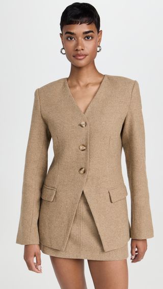 a model wears a light-brown blazer