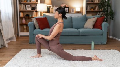 woman in lunge stretch on floor