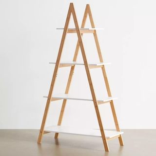 A bamboo triangle frame bookshelf has four different sized white shelves