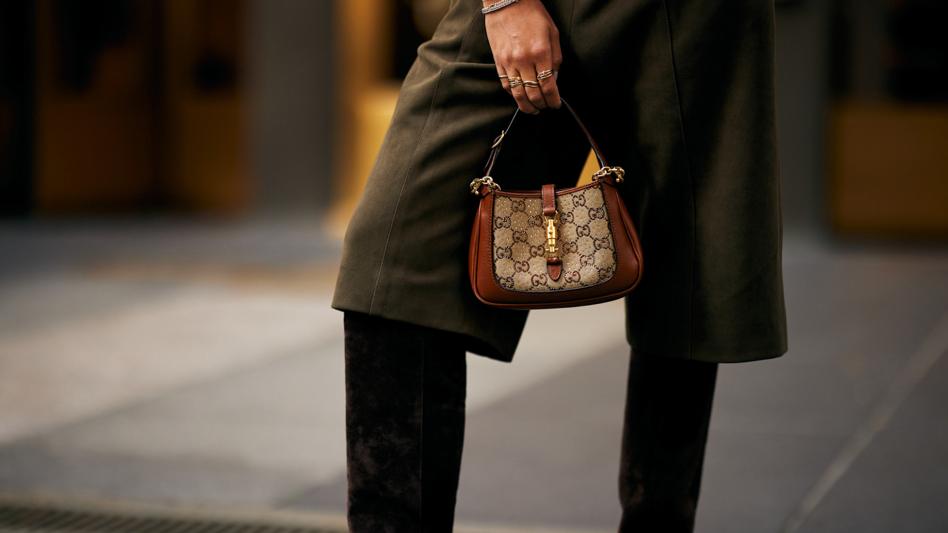 person holding a gucci bag