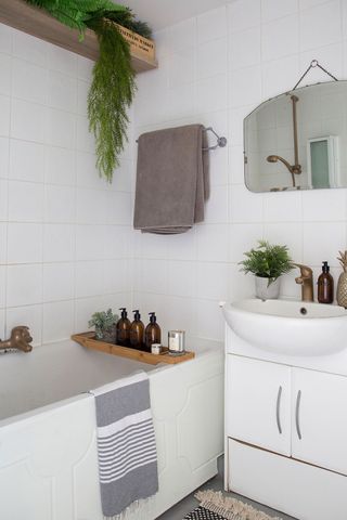 Bathroom with white walls wash basin and towels