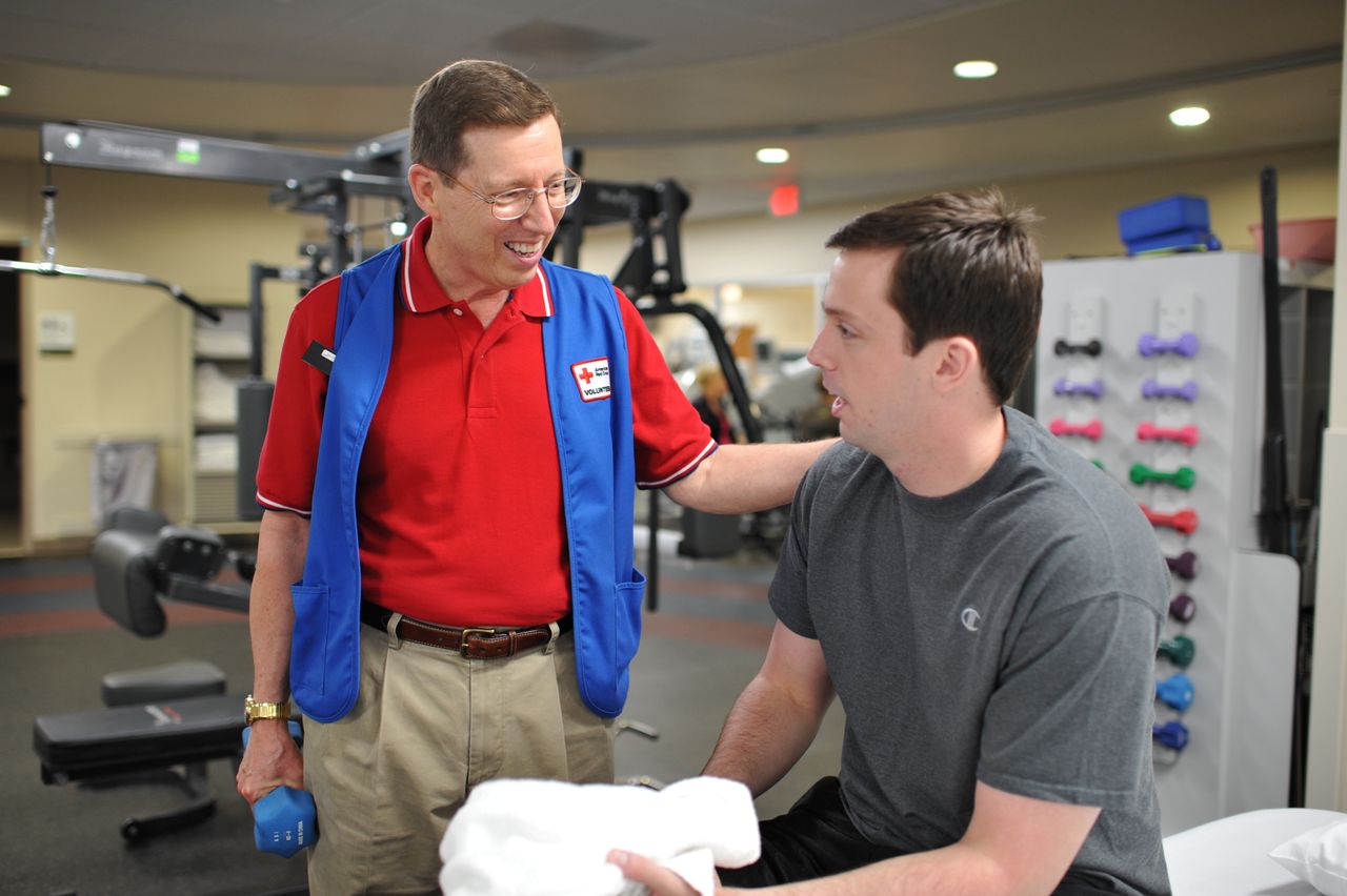 Steve Peth volunteering in the Military Advanced Training Center and working with an amputee.