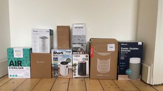 Boxes of all the air purifiers that I test