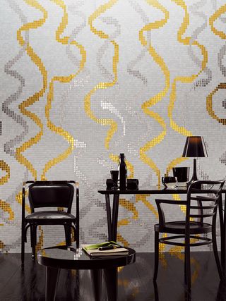 wall is soft gold ribbons gracefully intersecting upon a white background with black table and chairs in front