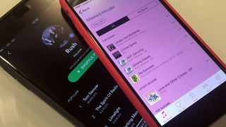 An image of mobile phones running Apple Music and Spotify apps