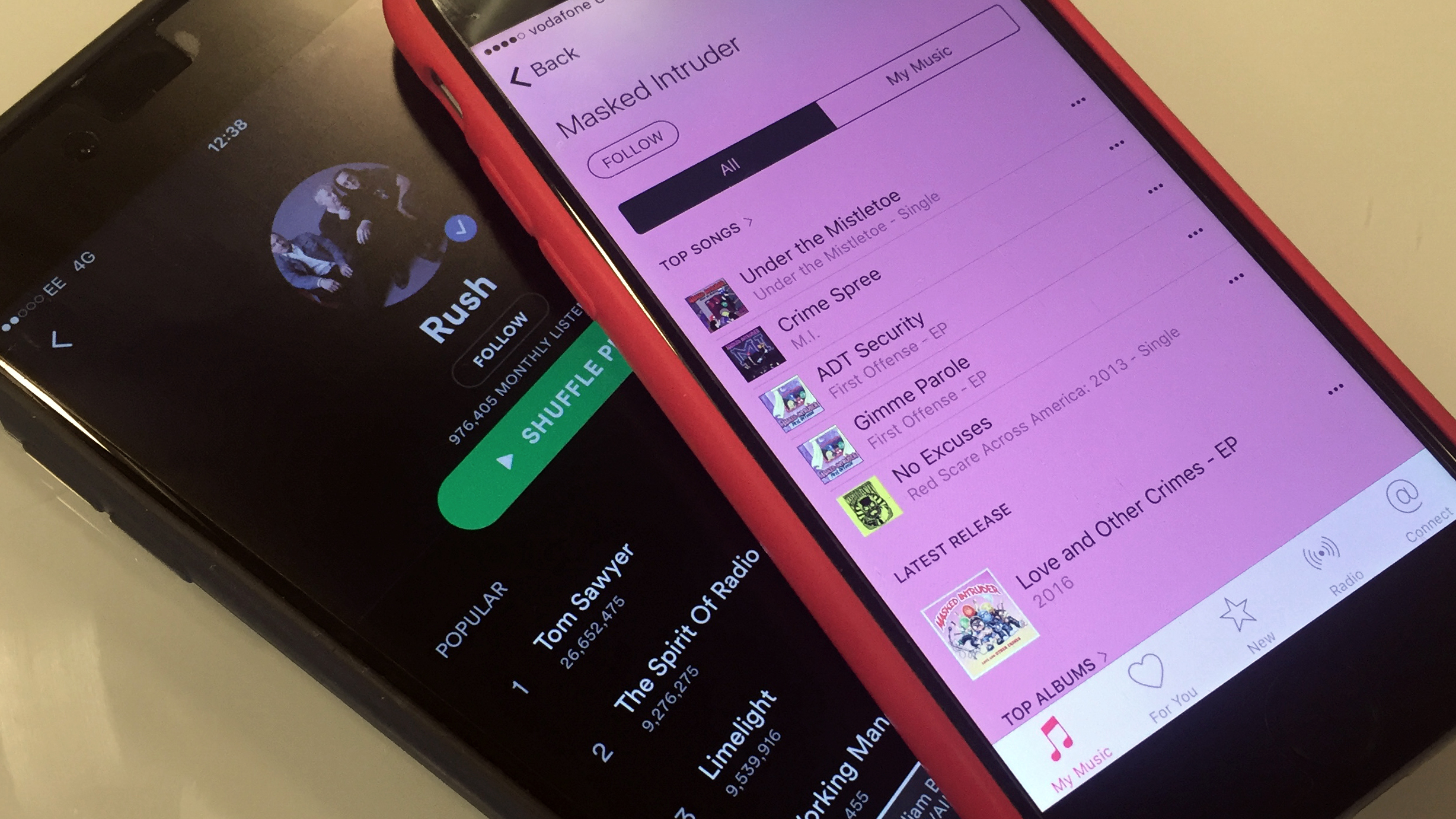 An image of mobile phones running Apple Music and Spotify apps