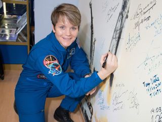 NASA astronaut Anne McClain signed a wall at the Baikonur Cosmodrome Museum in Kazakhstan on Nov. 29, a traditional task for astronauts pre-launch.
