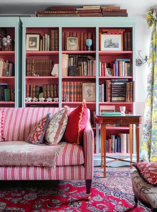 Living room with home library bookcase with red covers