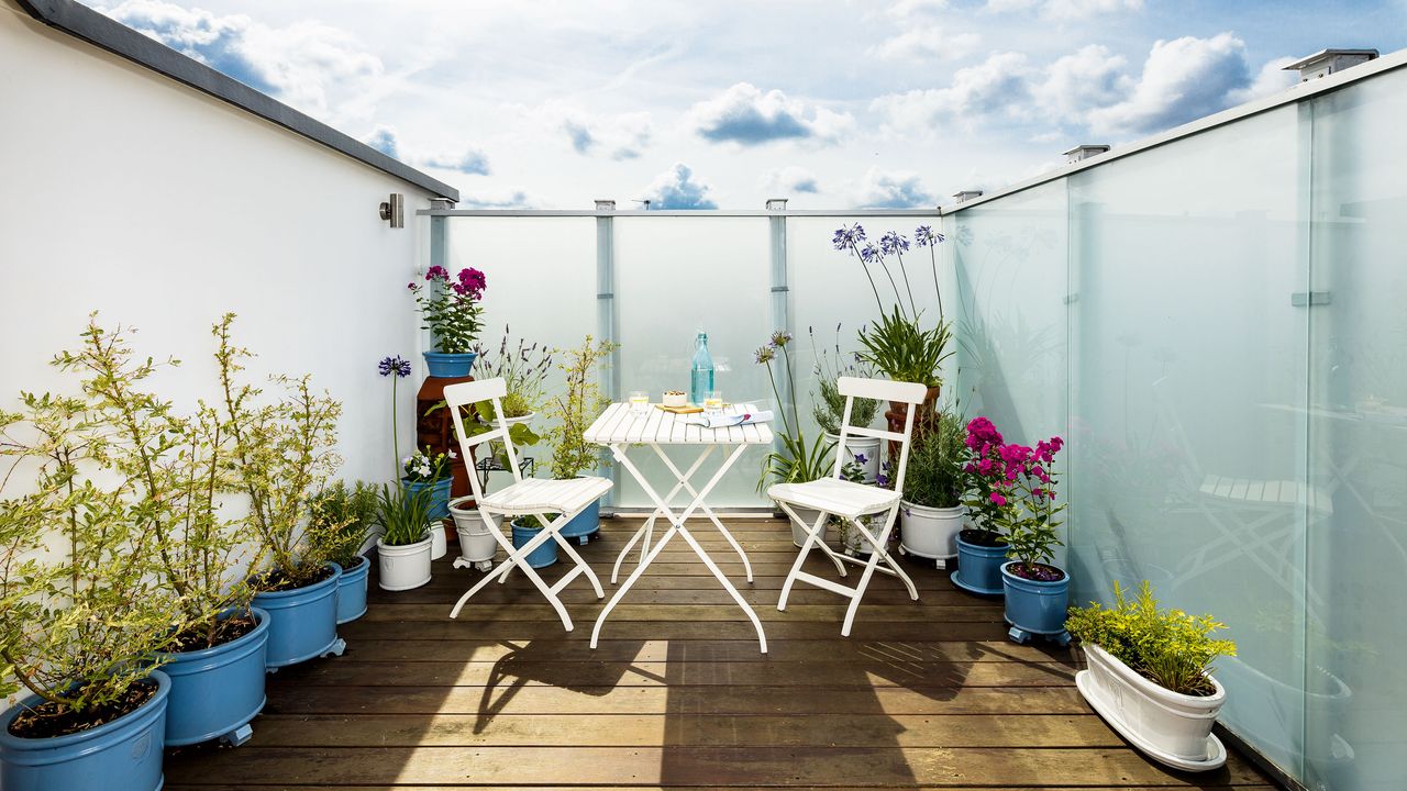 Balcony with white bistro set