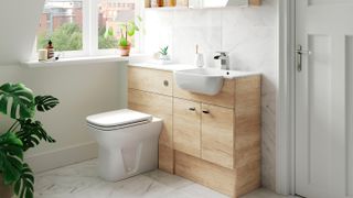 small bathroom with light wood furniture