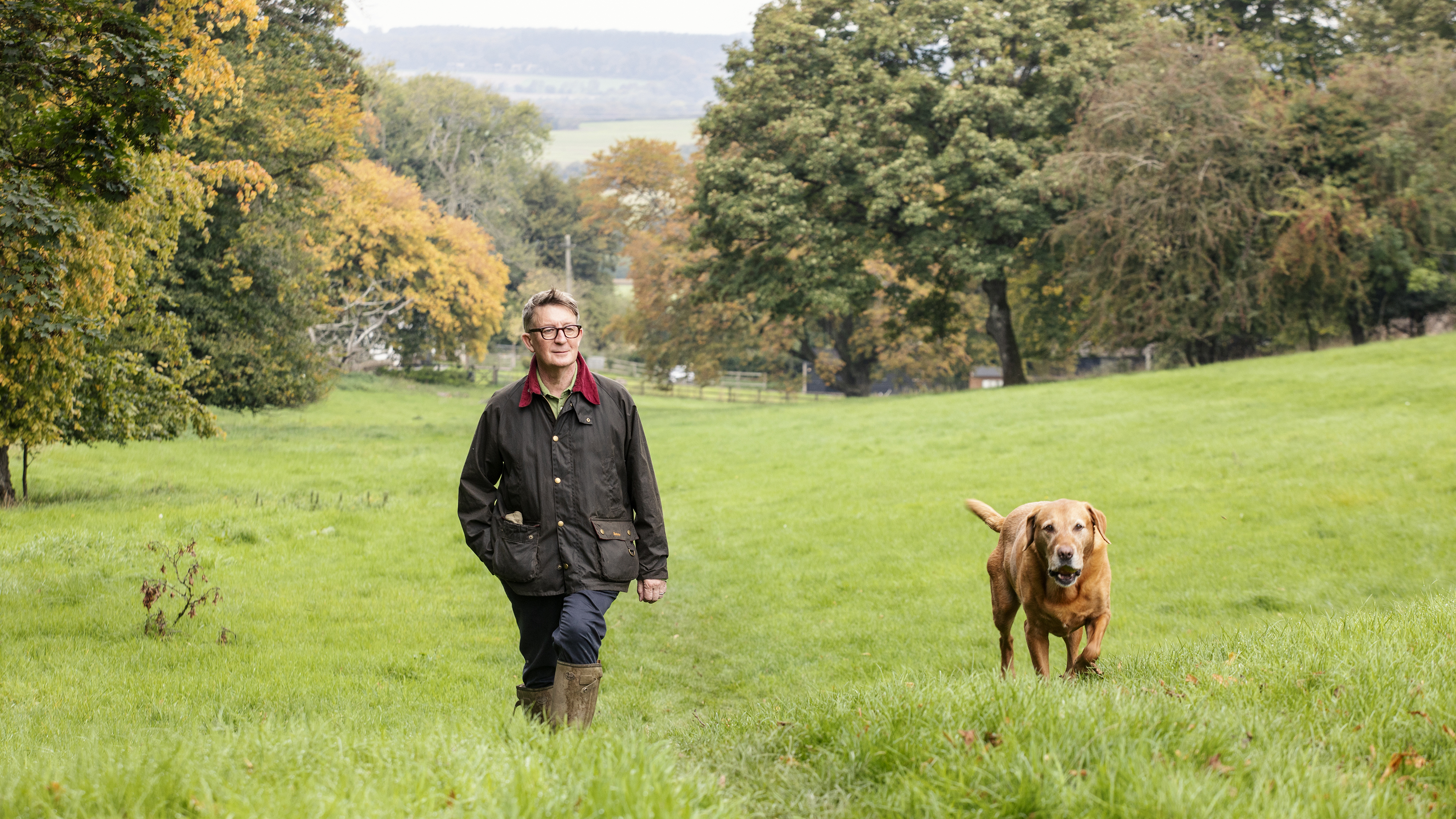 Mark Hedges walking his labrador near his home in the South Downs 