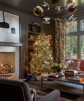 Dark living room with pink couch and christmas tree