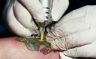 Even in otherwise hygienic tattoo parlors, the ink could harbor infectious bacteria. 