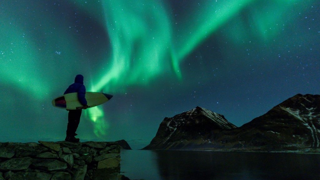 How Auroras Form: Electrons Surf Electromagnetic Waves Toward Earth