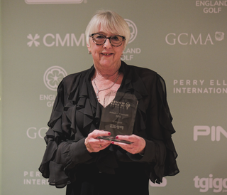 Barbara Tucker holding her award