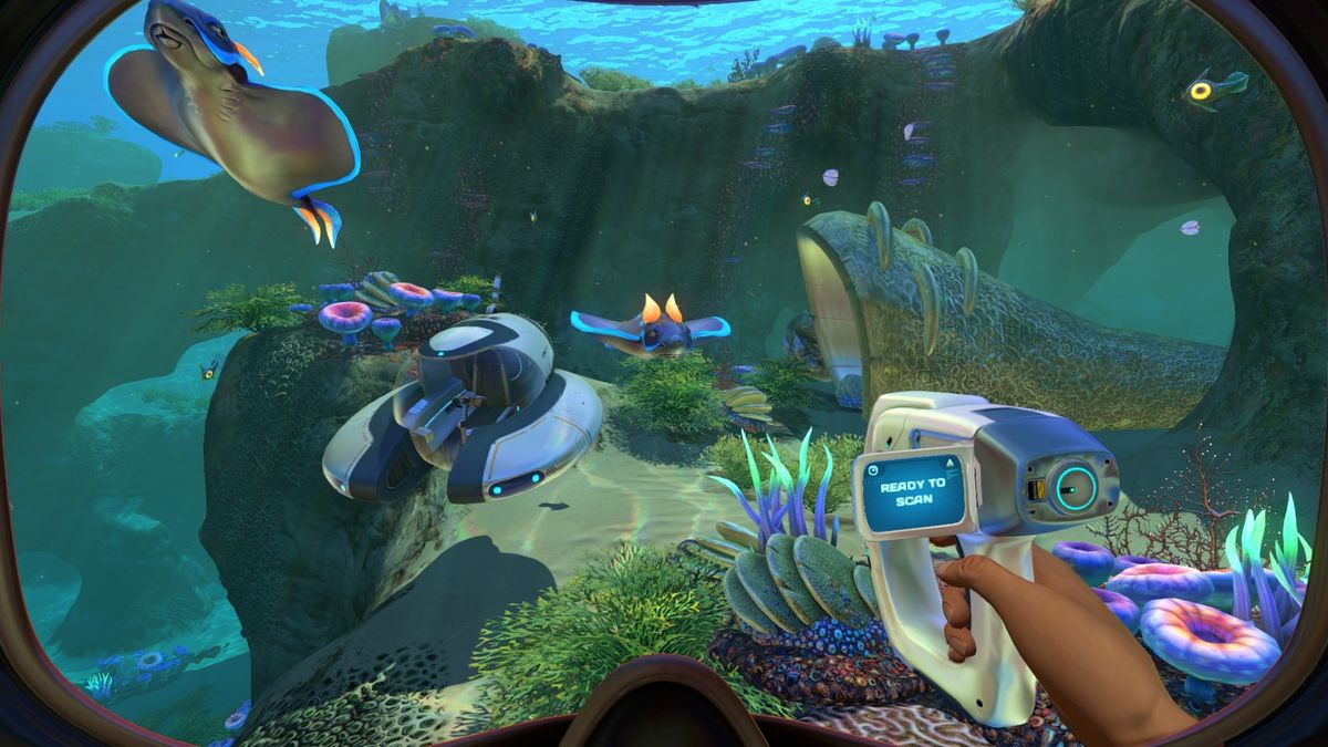 Screenshot from Subnautica showing two sea creatures swimming underwater amongst grass and coral