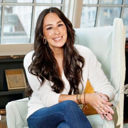 Joanna Gaines sits in armchair