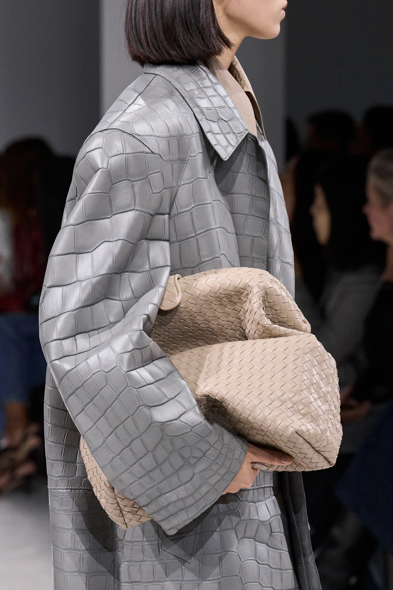 Close-up images of a model at the S/S 26 Bottega Veneta show wearing gray.