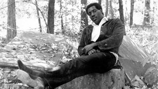 Itis Redding relaxing in a woodland
