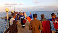 Rescuers work near the site where a boat sank in the Red Sea, in Marsa Alam