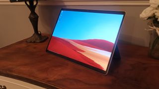A Microsoft Surface Pro X on a wooden table