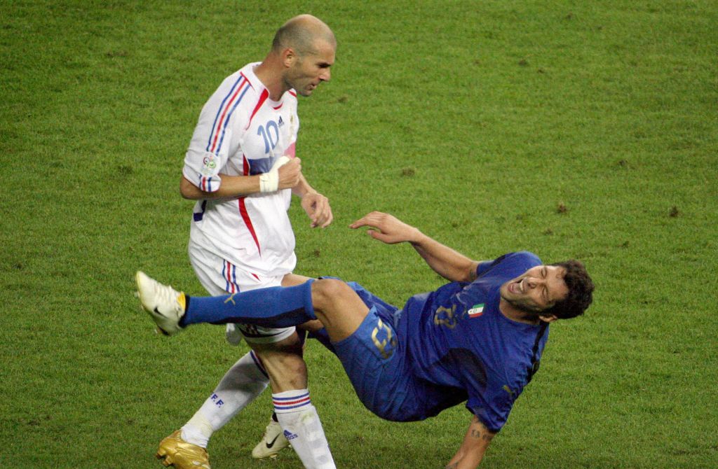 TOPSHOT - A photo taken 09 July 2006 shows French midfielder Zinedine Zidane (L) gesturing after head-butting Italian defender Marco Materazzi during the World Cup 2006 final football match between Italy and France at Berlins Olympic Stadium. AFP PHOTO JOHN MACDOUGALL (Photo by JOHN MACDOUGALL / AFP) (Photo by JOHN MACDOUGALL/AFP via Getty Images)