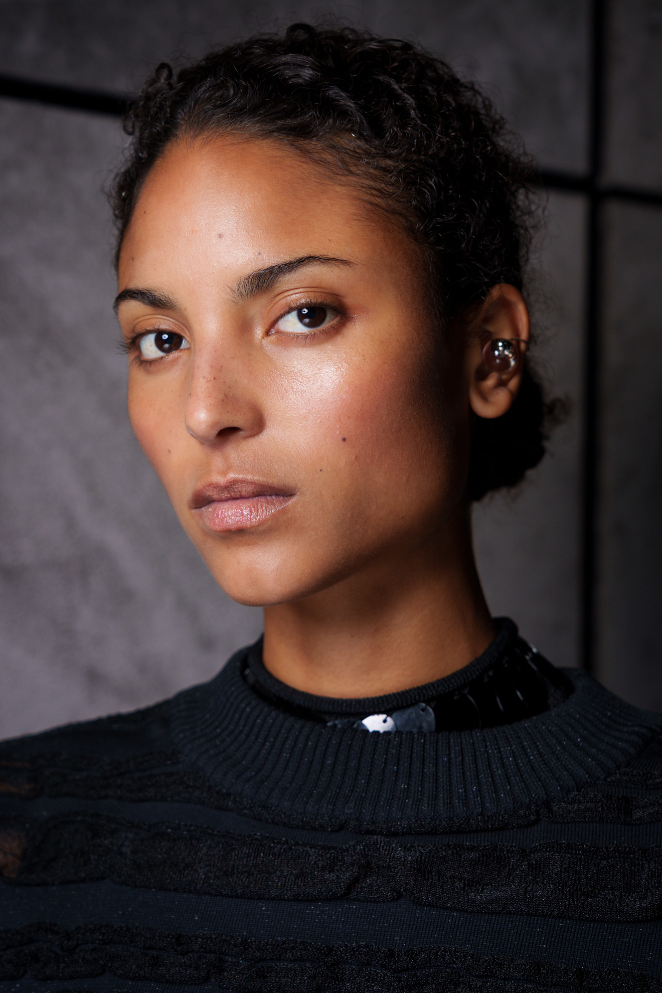 A model at the Thom Browne Spring-Summer 2026 show with luminous skin.