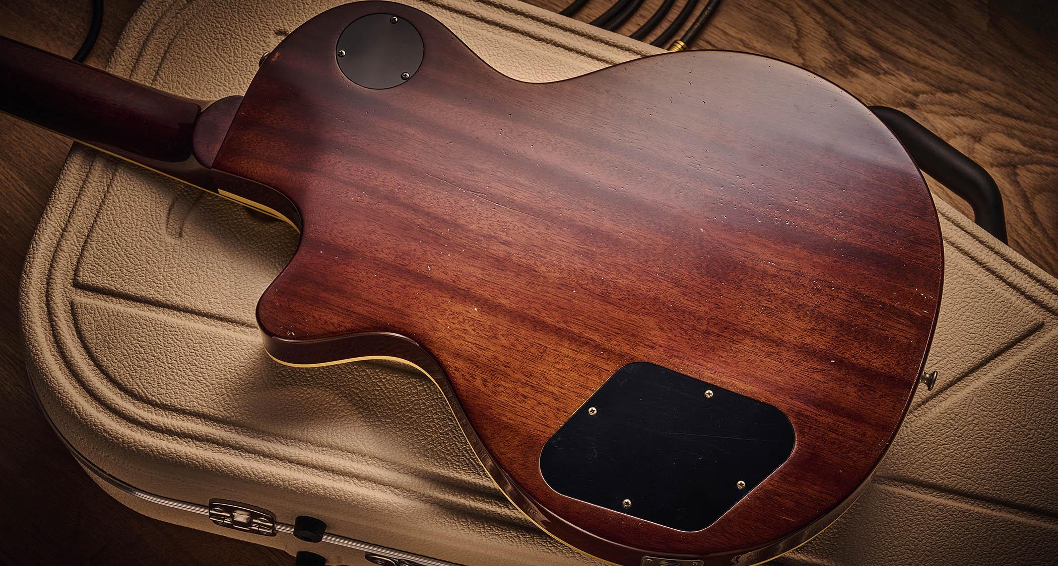 Ivison Dakota Standard in Cadillac Green photographed against its cream-covered Hiscox hard-shell guitar case.