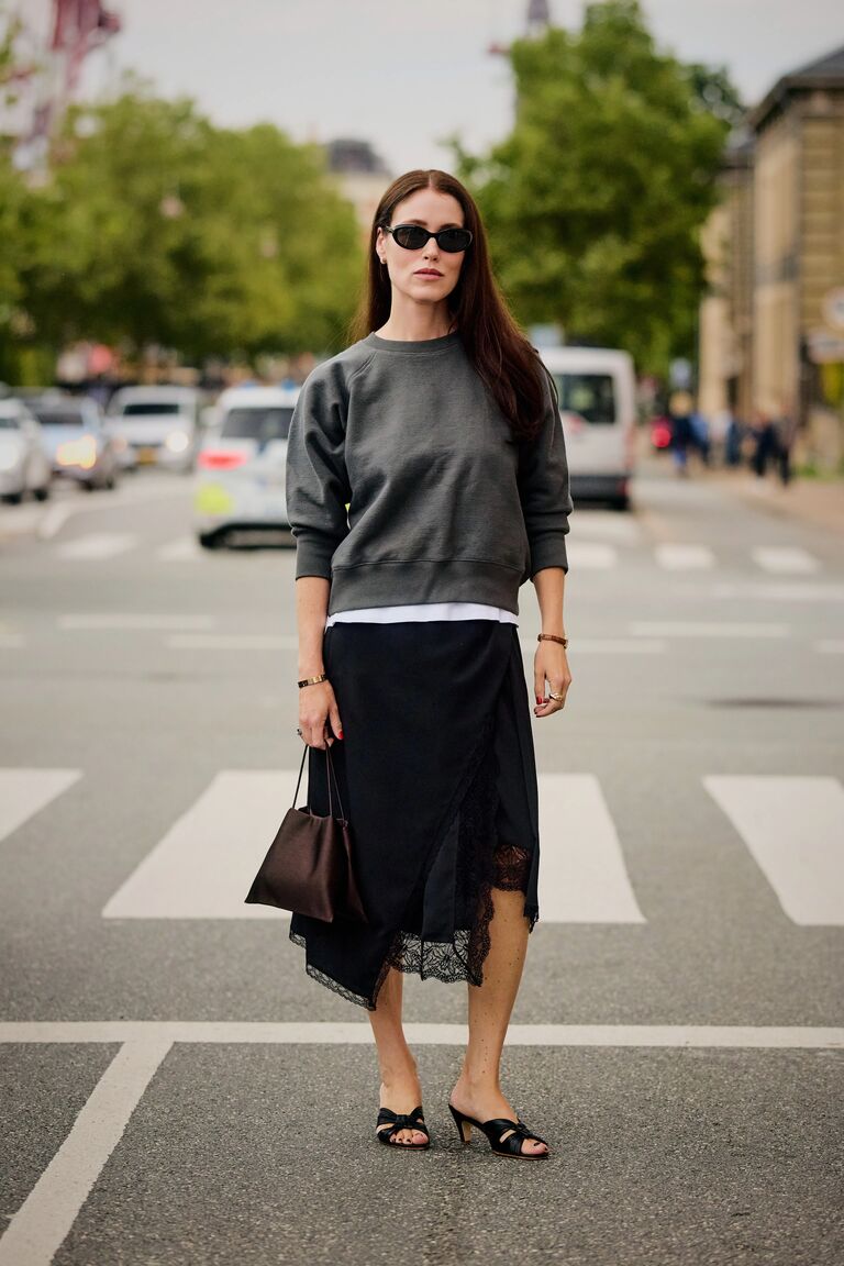 Woman in sweatshirt and lace-trim skirt