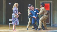 The main character De Rocher is held back by prison guards